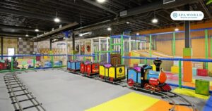 kids indoor play area in houston with train, slides, tunnel setup and more